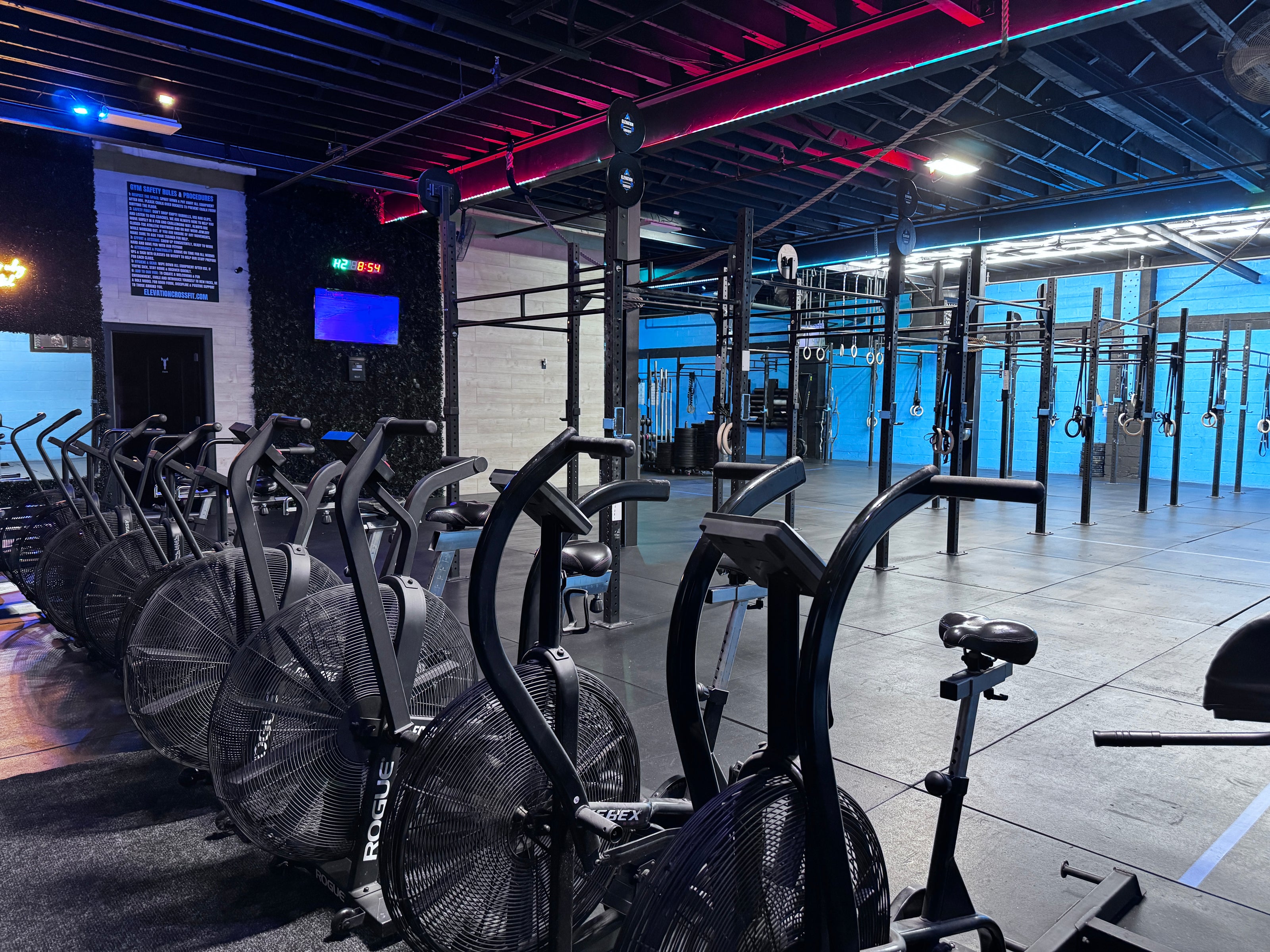 Gym interior with stationary bikes and fitness equipment.