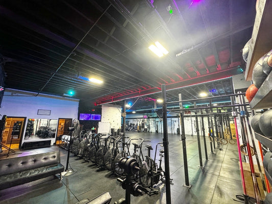 new jersey crossfit gym with bikes pull up bars weights with led ights on the roof.